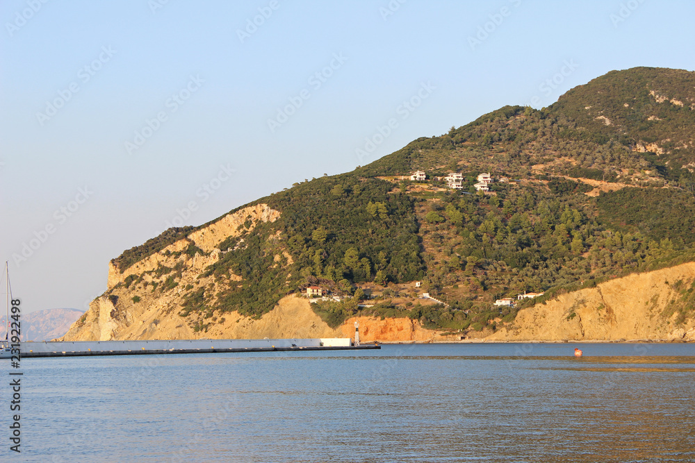 Hillside with houses next to Skopelos town harbor port island greece mediterranean  houses