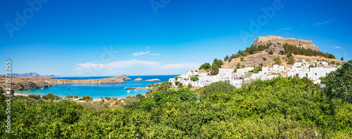Panoramic view of Acropolis of Lindos, traditional houses and lemon trees (Rhodes, Greece)
