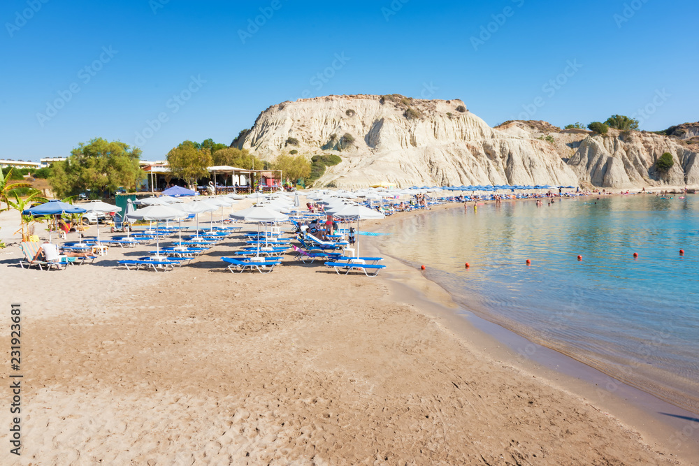 Kolymbia beach with umbrellas and sunbeds (Rhodes, Greece)