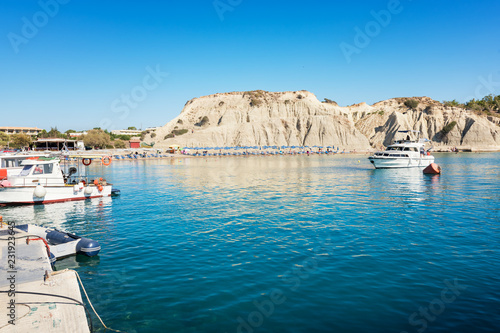 Kolymbia beach with umbrellas, sunbeds and boats (Rhodes, Greece)