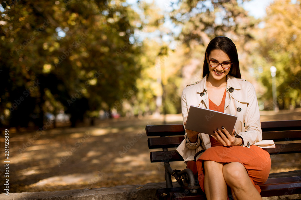 Young woman using digital tablet in the park Young woman using digital tablet in the park