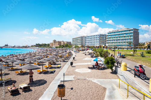 Elli beach with sunshades, sun beds and hotels in city of Rhodes (Rhodes, Greece)