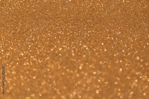 Sparkle glittering background. Glitter vintage lights background. Gold. De-focused. Abstract bokeh lights.