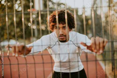 Young man stretching during...