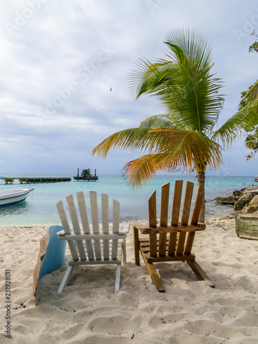 La Romana  Dominican Republic - Beautifull Beach with deckchairs  tropical palm and white sand of a typical island of the caribbean