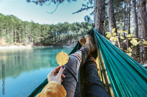 Принти на полотні Woman relaxing in the hammock by the lake