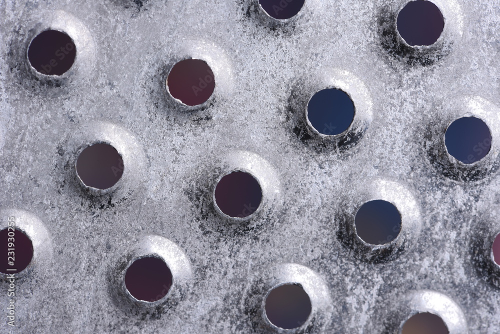 Metal plate with holes background Metal plate with holes background