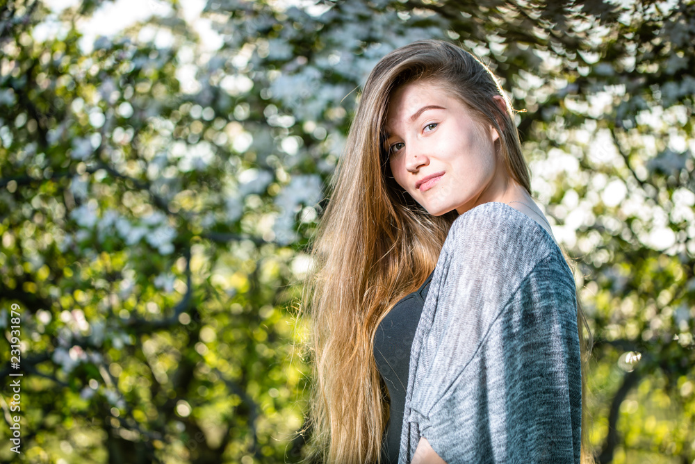 Beautiful young natural woman in spring flowers of apple orchard Beautiful young natural woman in spring flowers of apple orchard
