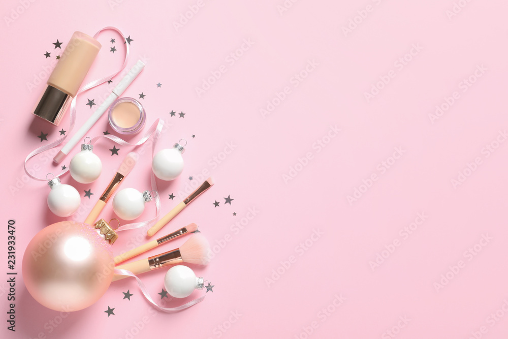 Flat lay composition with makeup products and Christmas decor on color background. Space for text