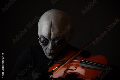 Alien enjoying playing violin  