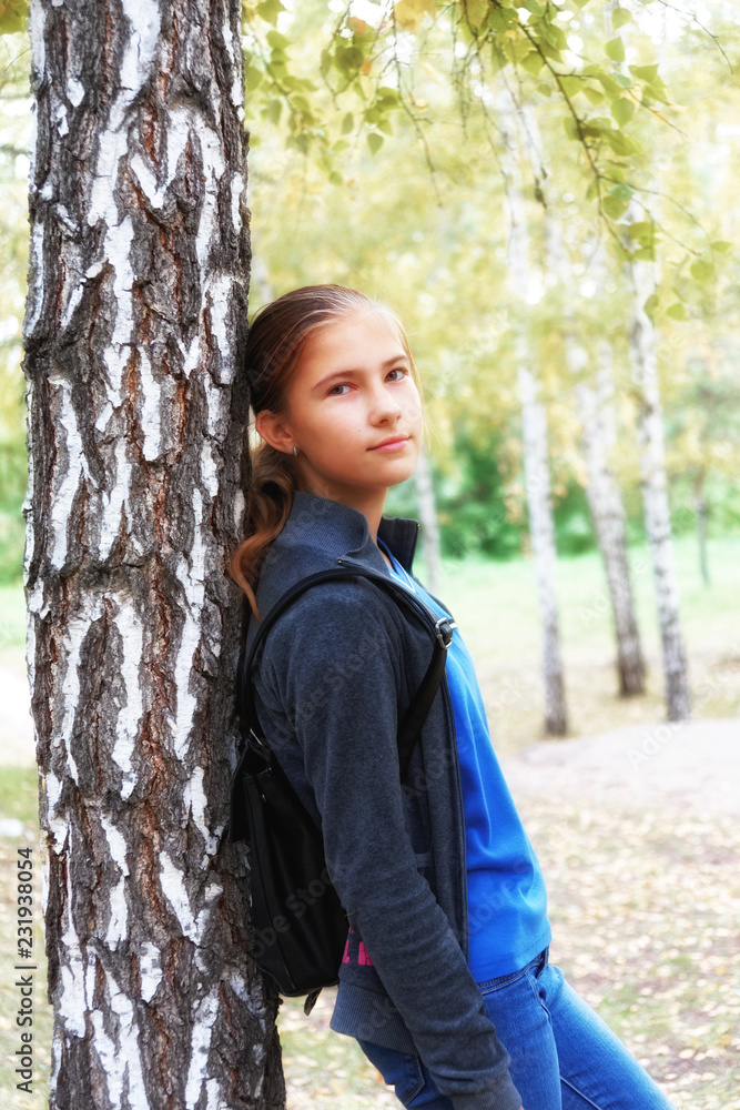 Romantic mood in a teen girl in an autumn birch grove. Soft focus image
