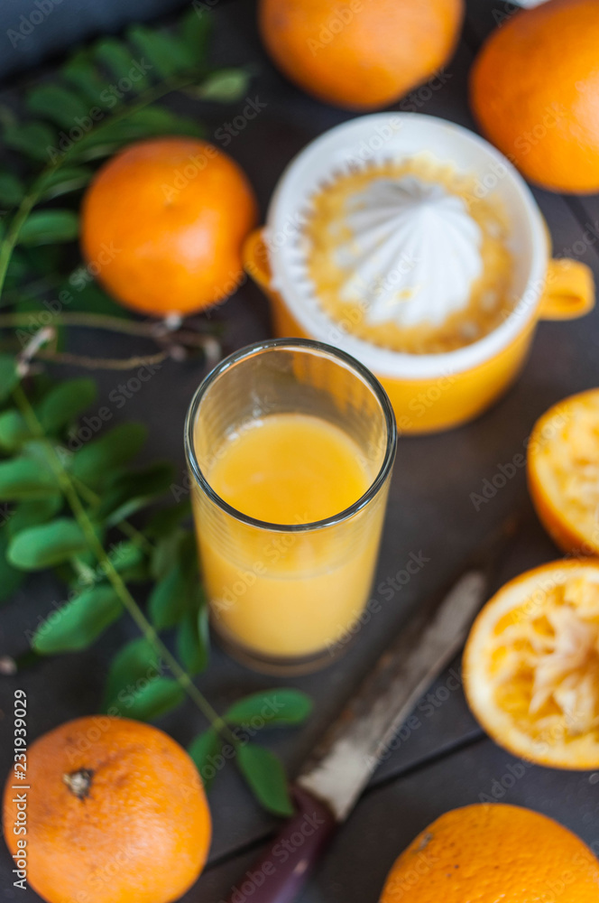 Oranges and juicer for making orange juice.. Black-gray background. Oranges and juicer for making orange juice.. Black-gray background.