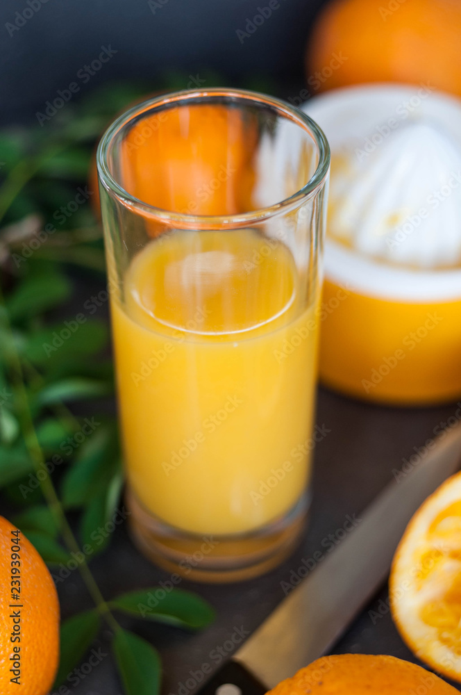 Oranges and juicer for making orange juice.. Black-gray background. Oranges and juicer for making orange juice.. Black-gray background.