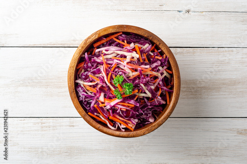Photos Fresh coleslaw salad with red and white cabbage and carrots in bowl on white wooden background