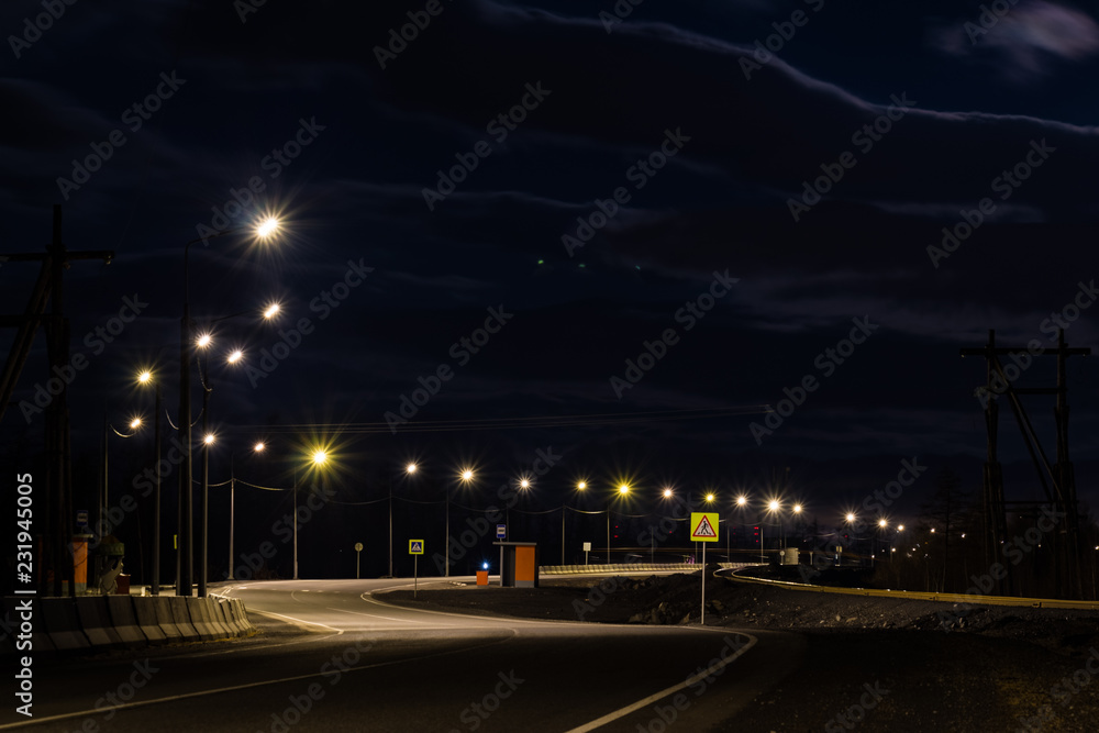 Fototapeta premium Crosswalk and busstop on a suburb road, Norilsk