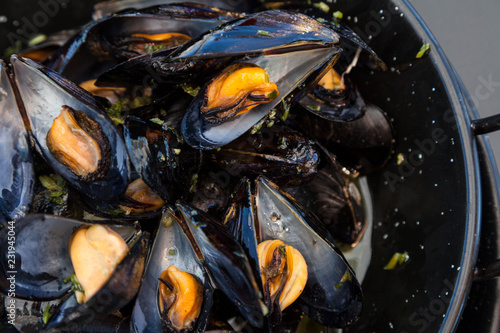 Traditional barbecue spanish  mussel in a black casserole photo