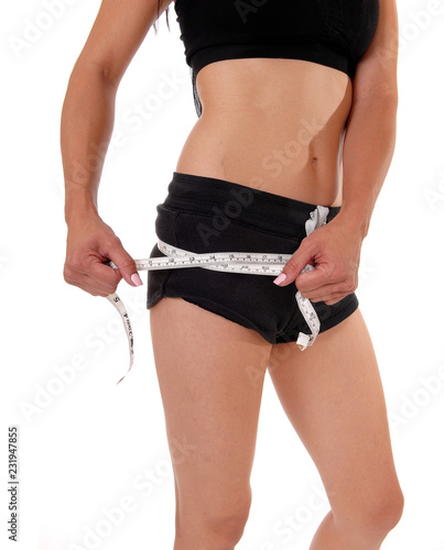 Close up of woman measuring her hips