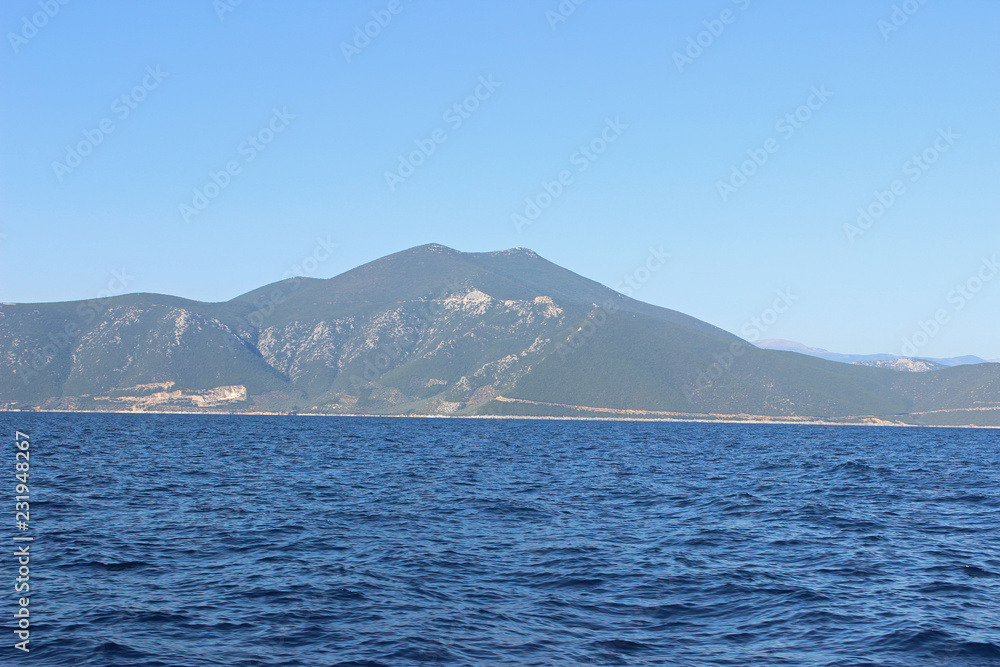 Sea landscape seascape deep blue calm sea ocean land island mountain hill on horizon