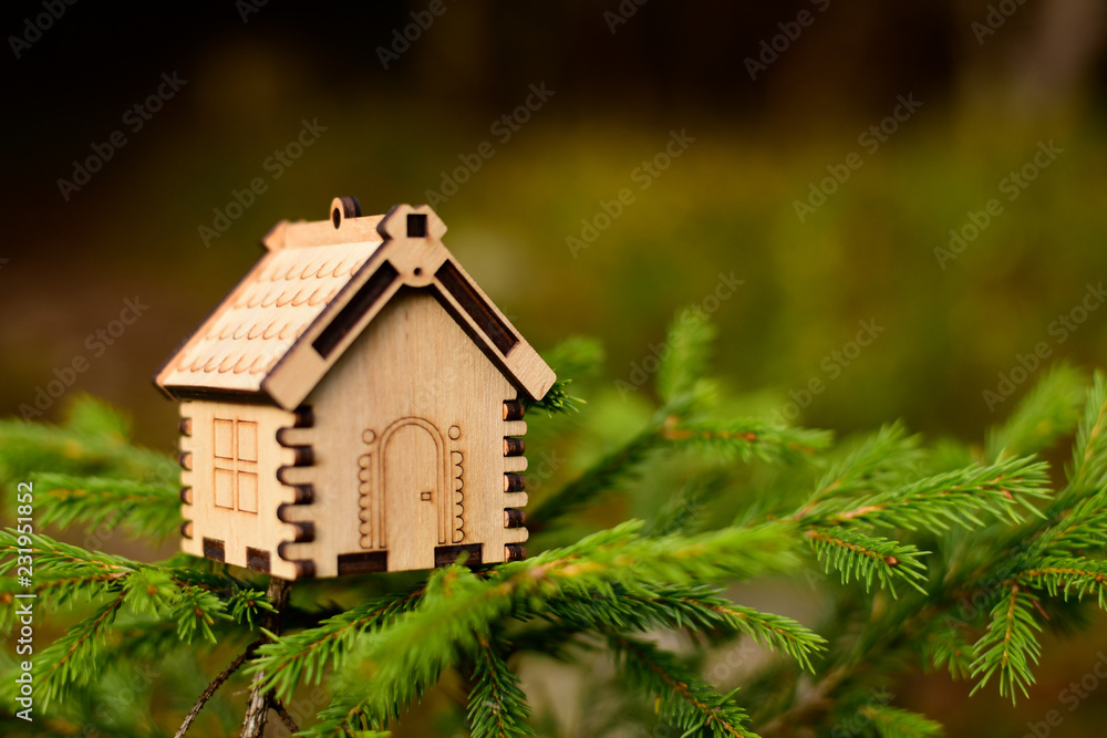 Wooden house model in the forest. concept Wooden house model in the forest. concept