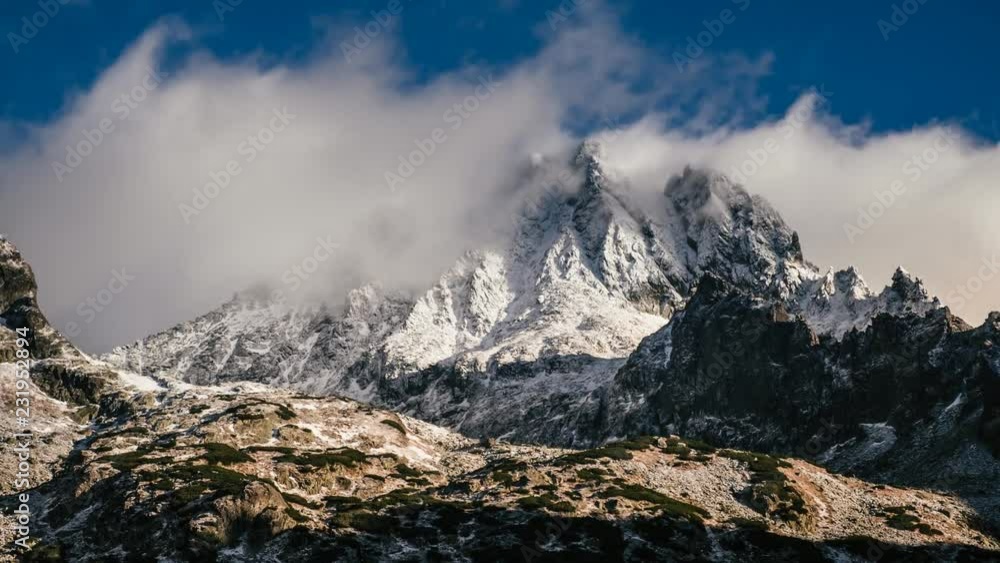 Snowy and cloudy time lapse mountain landscape from Rysy peaks at winter with blue sky on background, Slovakia. Snowy and cloudy time lapse mountain landscape from Rysy peaks at winter with blue sky on background, Slovakia.