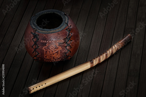 Calabash and bombilla on wooden background photo