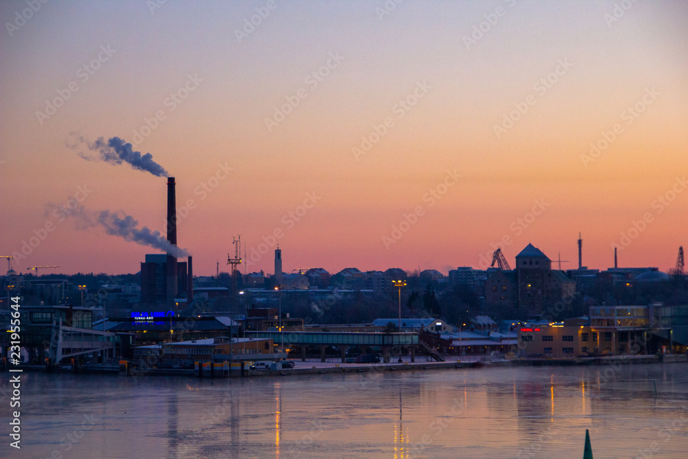 Industrial scenery at sunrise of Turku with refinery next to the water, Finland