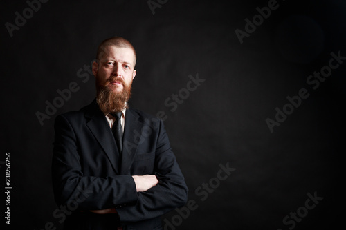 Confident businessman. Confident middle-age bearded man in formalwear keeping his arms crossed and looking at camera while standing i