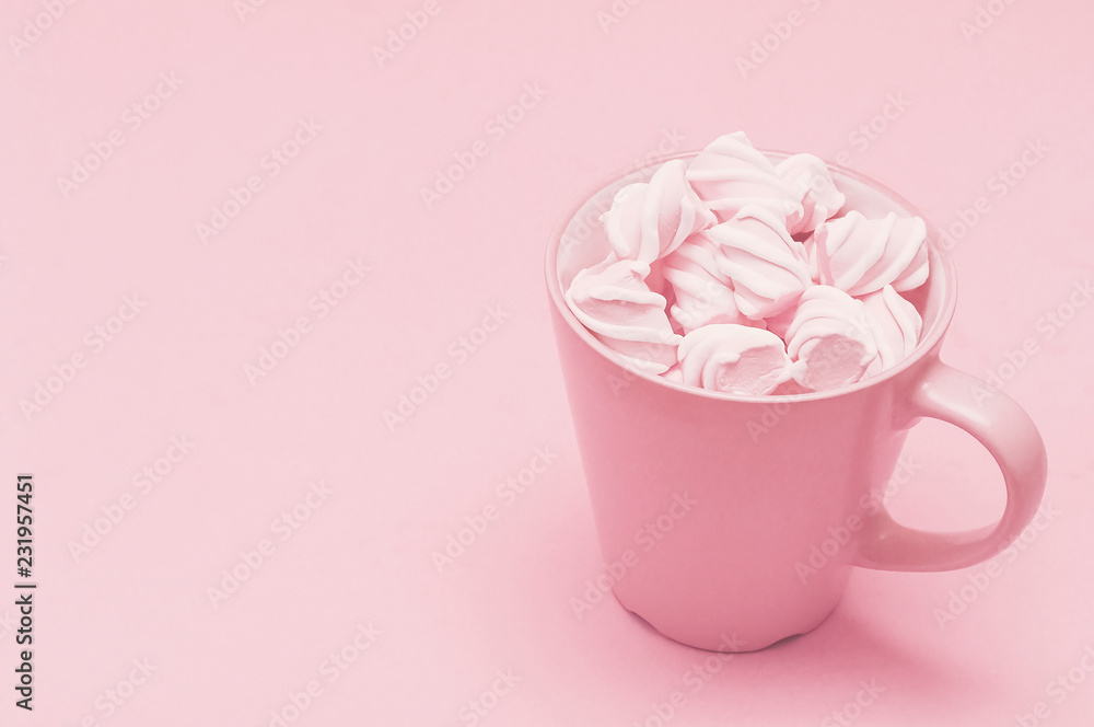 A cup and vanilla cakes on a pink background. Pastel color background. Close up A cup and vanilla cakes on a pink background. Pastel color background. Close up