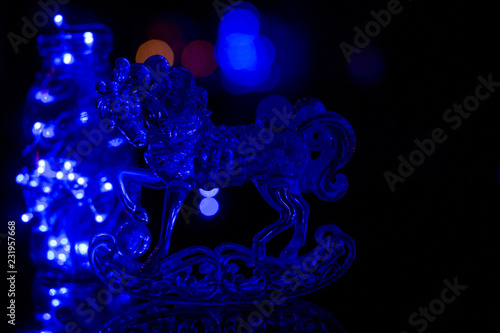 Transparent figure of a horse. Glass horse on black background.