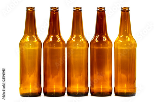 Colored empty glass bottles on white background