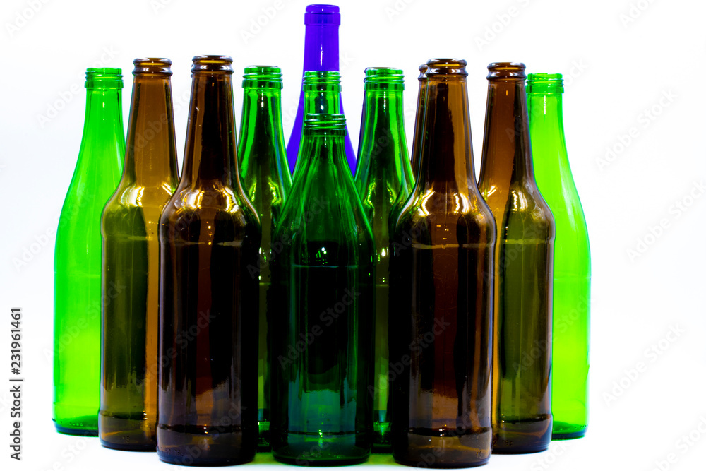 Colored empty glass bottles on white background