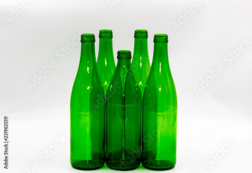 Colored empty glass bottles on white background