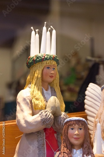 Swedish Christmas figure with candle crown on the head of Saint Lucia, a Christian martyr that is celebrated on 13th of December in Scandinavian countries photo