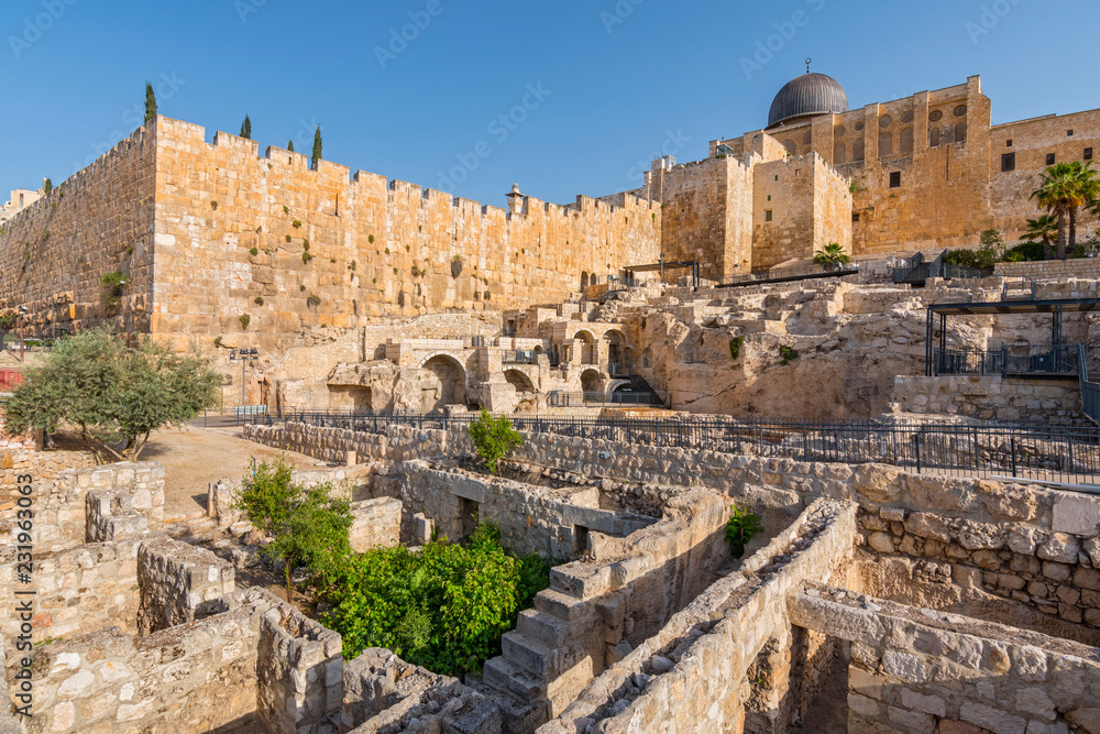 Dome of Al Aqsa Mosque surrounded by walls and ancient ruins in Old City of Jerusalem, Israel.