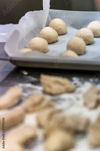 Small Bread Dough Balls Placed on Cooking Paper on Pan - Ready to be Baked
