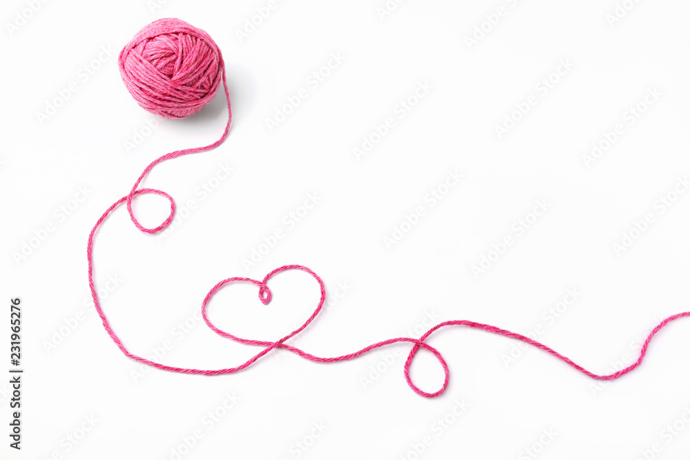 Pink thread, heart and tangle on white background Stock Photo