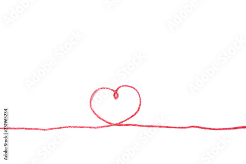Red thread and heart isolated on white background