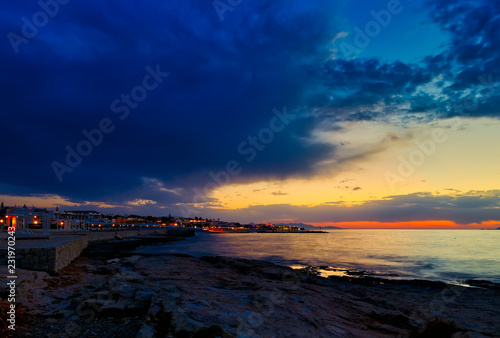 Beautiful sunset in western part of island of Crete  near town of Hersonissos. beach resort Seascape. Sunset over the sea.