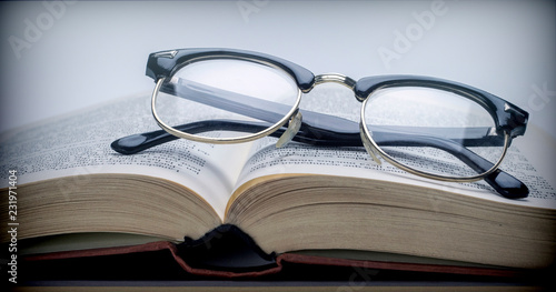 Glasses vintage on a book isolated on white background