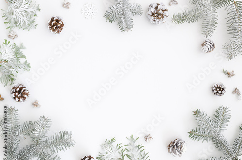 Christmas greeting card. Christmas frame border with copy space. Noel festive background. New year symbol. Fir branches snow and pine cones. Minimal flat lat xmas design photo