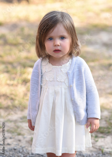 portrait of little girl outdoors in summer