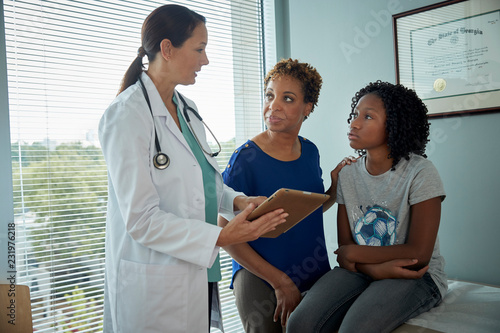 Doctor talking with mother and daughter