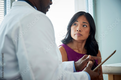 Doctor speaking with a female patient photo