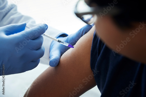 Patient being given an injection by a doctor photo
