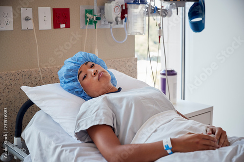 Female patient lying in hospital bed,