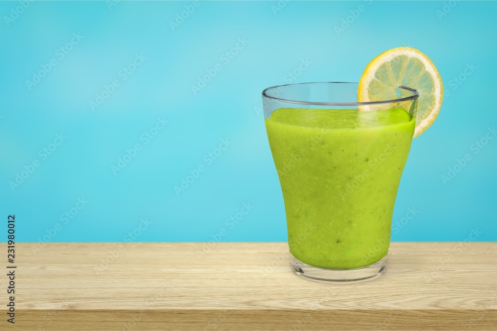 Glass of fresh juice on wooden table Glass of fresh juice on wooden table