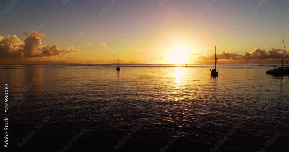 boat with Sunset in aerial view , french polynesia boat with Sunset in aerial view , french polynesia