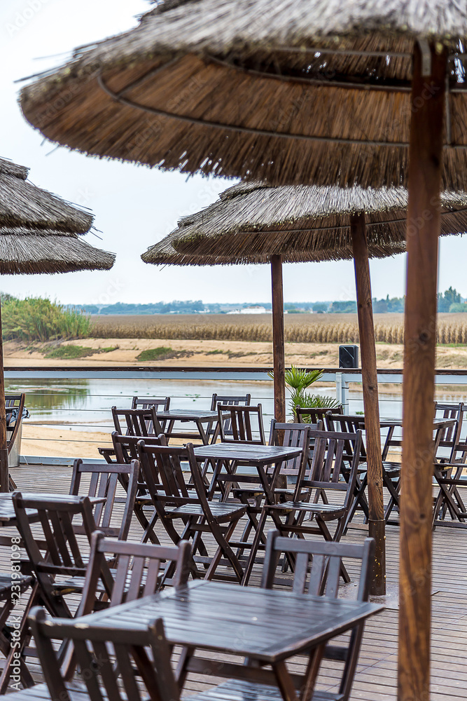 Coffee Terrace By The River with Wooden Chairs and Tables