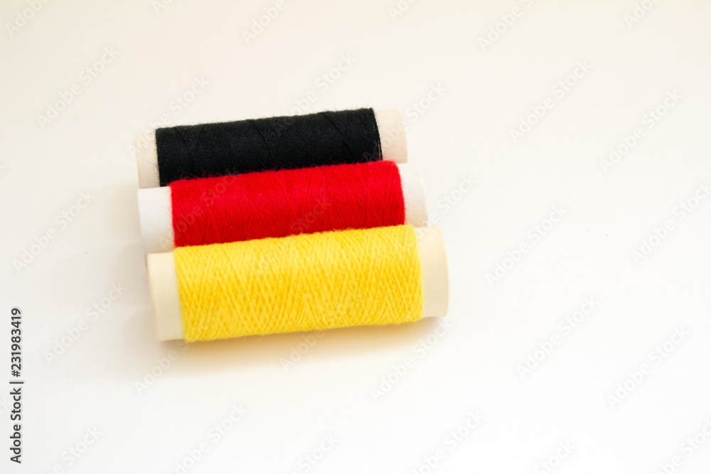Coils of thread in the shape of the flag of Germany Coils of thread in the shape of the flag of Germany