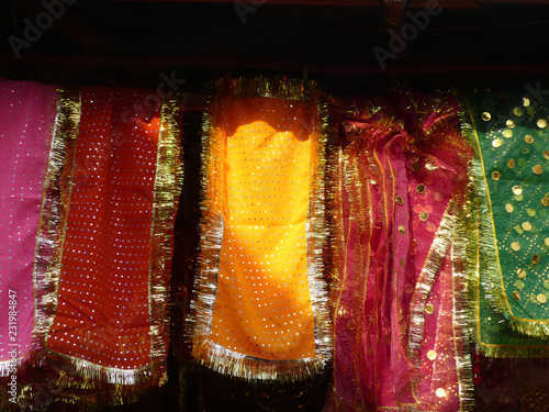 Multi-colored cloth hanging outside a mosque, New Delhi, India photo